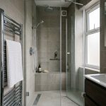 a modern lived-in shower cabin in a contemporary London apartment bathroom, immediately after a meticulous professional deep-clean